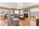 Inviting living room featuring a fireplace, hardwood floors, and an adjacent dining area at 39335 Harbor Hills Blvd, Lady Lake, FL 32159