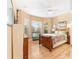 Bright main bedroom with natural light, ceiling fan, and stylish wooden furniture at 39335 Harbor Hills Blvd, Lady Lake, FL 32159