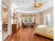 Bright main bedroom showcases hardwood floors, a ceiling fan, and views of the yard at 39335 Harbor Hills Blvd, Lady Lake, FL 32159