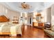 Main bedroom featuring hardwood floors, a ceiling fan, and access to the ensuite at 39335 Harbor Hills Blvd, Lady Lake, FL 32159