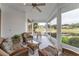 Relaxing screened porch with wicker furniture and scenic views at 39335 Harbor Hills Blvd, Lady Lake, FL 32159