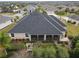 Aerial view showcasing home's roofline, screened porch, and backyard at 4038 Swaying Palm Ct, The Villages, FL 32163