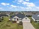 House with a large backyard and a view of the water at 4038 Swaying Palm Ct, The Villages, FL 32163