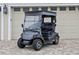 Grey Yamaha golf cart parked in front of garage at 4038 Swaying Palm Ct, The Villages, FL 32163