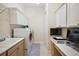 Bright laundry room with washer, dryer, cabinets, and workspace at 4038 Swaying Palm Ct, The Villages, FL 32163