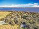 Aerial view showing homes near a vast body of water at 405 Mission Ln, Howey In The Hills, FL 34737