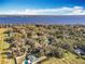 Aerial view showcasing a neighborhood with houses near the water at 405 Mission Ln, Howey In The Hills, FL 34737