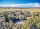 Aerial view of homes situated amongst lush trees near water at 405 Mission Ln, Howey In The Hills, FL 34737