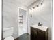 Modern bathroom with dark vanity and marble-look tile at 405 Mission Ln, Howey In The Hills, FL 34737