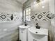 Modern bathroom with double vanity, patterned tile, and window at 405 Mission Ln, Howey In The Hills, FL 34737