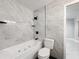 Bathroom with soaking tub and gray marble-look tile at 405 Mission Ln, Howey In The Hills, FL 34737