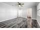 Bright bedroom with wood-look floors and ceiling fan at 405 Mission Ln, Howey In The Hills, FL 34737