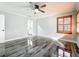 Light and airy bedroom featuring wood-look floors and a ceiling fan at 405 Mission Ln, Howey In The Hills, FL 34737