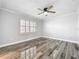 Spacious bedroom featuring wood-look floors and ceiling fan at 405 Mission Ln, Howey In The Hills, FL 34737