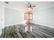 Spacious bedroom with wood-look floors, large windows, and ceiling fan at 405 Mission Ln, Howey In The Hills, FL 34737