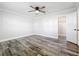 Well-lit bedroom with wood-look floors and ceiling fan at 405 Mission Ln, Howey In The Hills, FL 34737