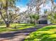 Front view of the house, driveway, and surrounding landscape at 405 Mission Ln, Howey In The Hills, FL 34737