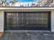 Attached garage with a dark-colored door at 405 Mission Ln, Howey In The Hills, FL 34737