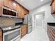 Modern kitchen with stainless steel appliances and wood cabinets at 405 Mission Ln, Howey In The Hills, FL 34737