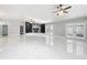 Open living space with marble floors, fireplace, and French doors at 405 Mission Ln, Howey In The Hills, FL 34737