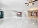 Large living room with marble floors, kitchen island, and high ceilings at 405 Mission Ln, Howey In The Hills, FL 34737