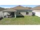 Large backyard with covered patio and grassy area at 417 Pinecrest Loop, Davenport, FL 33837