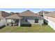 Spacious backyard with patio, grill, and fenced perimeter at 417 Pinecrest Loop, Davenport, FL 33837