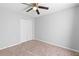 Well-lit bedroom with ceiling fan and double-door closet at 417 Pinecrest Loop, Davenport, FL 33837