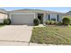 Curb appeal of a one-story house with gray siding and a two-car garage at 417 Pinecrest Loop, Davenport, FL 33837