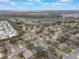 Aerial view showcasing the property's location in a residential neighborhood near a lake at 4520 Abaco Dr, Tavares, FL 32778