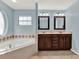 Bathroom boasts a large soaking tub and double vanity at 4520 Abaco Dr, Tavares, FL 32778