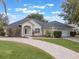 One-story house with a circular driveway and lush lawn at 4520 Abaco Dr, Tavares, FL 32778