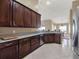 Modern kitchen with dark wood cabinets and granite countertops at 4520 Abaco Dr, Tavares, FL 32778