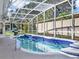 Relaxing kidney-shaped pool with a screened enclosure at 4520 Abaco Dr, Tavares, FL 32778