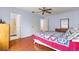 Bedroom with a queen bed, wood floors, and access to a bathroom at 453 Hildalgo Dr, Lady Lake, FL 32159