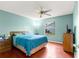 Blue bedroom with wood floors, a queen bed, and ceiling fan at 453 Hildalgo Dr, Lady Lake, FL 32159