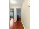 Hallway with wood flooring and doors leading to bedrooms at 453 Hildalgo Dr, Lady Lake, FL 32159