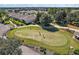 Aerial view of putting green with golfers at 4557 Antietam Creek Trl, Leesburg, FL 34748