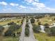 Aerial view of community entrance, golf course, and lake at 4557 Antietam Creek Trl, Leesburg, FL 34748