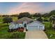 Beautiful house with three-car garage,solar panels, and a pond view at 4557 Antietam Creek Trl, Leesburg, FL 34748