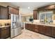 Modern kitchen with stainless steel refrigerator and granite counters at 4557 Antietam Creek Trl, Leesburg, FL 34748