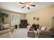 Relaxing sitting room with comfy seating and a large TV at 4557 Antietam Creek Trl, Leesburg, FL 34748