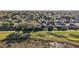 This is an aerial view of the homes nestled between a golf course and natural wetland at 4822 Sawgrass Lake Cir, Leesburg, FL 34748