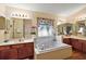 Bright bathroom featuring a soaking tub with tile surround and dual sink vanity at 4822 Sawgrass Lake Cir, Leesburg, FL 34748