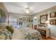 A bright bedroom with floral wallpaper, soft lighting, and a window view at 4822 Sawgrass Lake Cir, Leesburg, FL 34748