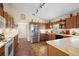 A kitchen with stainless steel appliances and tiled flooring at 4822 Sawgrass Lake Cir, Leesburg, FL 34748