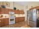 Well-lit kitchen featuring stainless steel appliances and tile flooring and ample cabinet space at 4822 Sawgrass Lake Cir, Leesburg, FL 34748