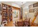 View of the library with floor to ceiling bookshelves, hardwood flooring, and stylish decor at 4822 Sawgrass Lake Cir, Leesburg, FL 34748