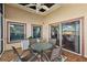 Inviting covered patio with ceiling fan, neutral tones, table with chairs, and sliding glass doors at 4822 Sawgrass Lake Cir, Leesburg, FL 34748