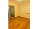 Bright bedroom with hardwood floors and sliding glass doors at 505 W 10Th Ave, Mount Dora, FL 32757